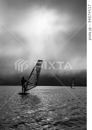 windsurfer silhouette on sunset background windsurfer silhouette on sunset background 94074517