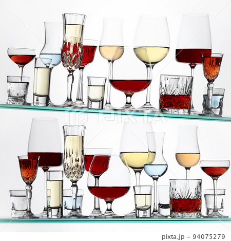 Various alcoholic drinks on a glass shelves. Various alcoholic drinks on a glass shelves. 94075279