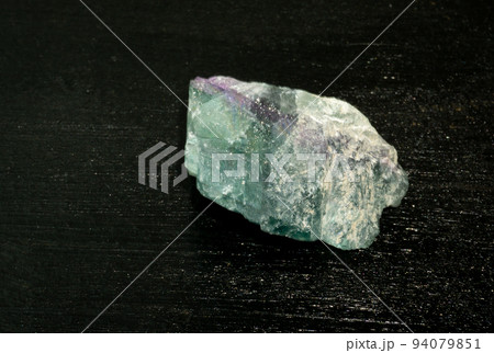 Fluorite fluorspar from Brazil. Natural mineral stone on black background. Mineralogy, geology, magic of stones, semi-precious stones and samples of minerals. Close-up macro photo. Fluorite fluorspar from Brazil. Natural mineral stone on black background. Mineralogy, geology, magic of stones, semi-precious stones and samples of minerals. Close-up macro photo. 94079851