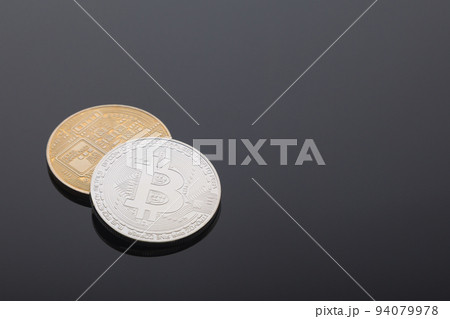 Golden and silver bitcoin cryptocurrency on black background Golden and silver bitcoin cryptocurrency on black background 94079978