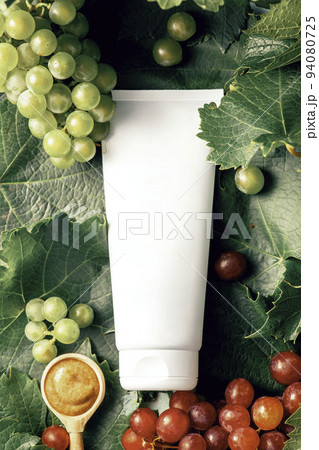 Tube of cream with anti-aging effect. Organic cosmetics with grape seed oil and herbal ingredients. Skincare cosmetic Tube of cream with anti-aging effect. Organic cosmetics with grape seed oil and herbal ingredients. Skincare cosmetic 94080725