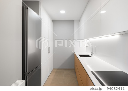 White empty modern kitchen with fridge, stove and sink 94082411