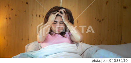 woman having migraine headaches during lying in bed at home. insomnia, sleepless, tired, suffering and stressed concepts 94083130