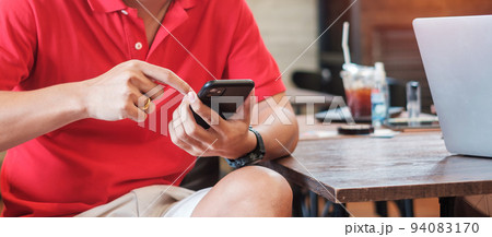 Casual Businessman holding and using smartphone for sms messages, young man typing touchscreen mobile phone in cafe or modern office. lifestyle, technology, Social media and network concept 94083170