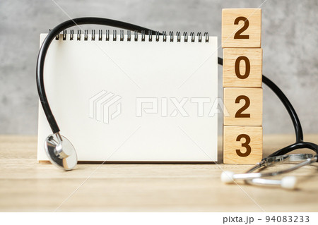 2023 Happy New Year for healthcare, Insurance, Wellness and medical concept. Stethoscope and blank notebook for copy space your text 2023 Happy New Year for healthcare, Insurance, Wellness and medical concept. Stethoscope and blank notebook for copy space your text 94083233