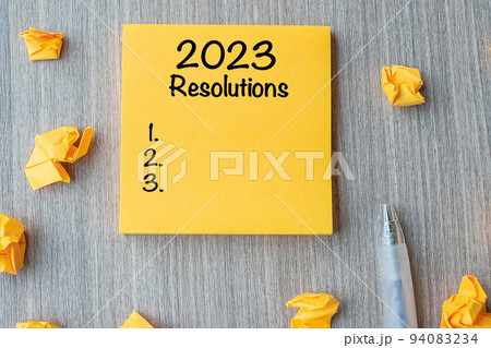 2023 RESOLUTIONS word on yellow note with pen and crumbled paper on wooden table background. New start, Strategy and Goal concept 2023 RESOLUTIONS word on yellow note with pen and crumbled paper on wooden table background. New start, Strategy and Goal concept 94083234