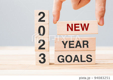 hand holding wooden block with text 2023 NEW YEAR NEW GOALS on table background. Resolution, strategy, solution, business and holiday concepts hand holding wooden block with text 2023 NEW YEAR NEW GOALS on table background. Resolution, strategy, solution, business and holiday concepts 94083251