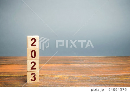 Wooden blocks with the inscription 2023. Setting goals and objectives for the new year. Planning, business management and strategy concept. Trends and ideas. Vision. Wooden blocks with the inscription 2023. Setting goals and objectives for the new year. Planning, business management and strategy concept. Trends and ideas. Vision. 94094576