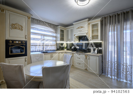 White classic cozy kitchen and dining room in city house 94102563