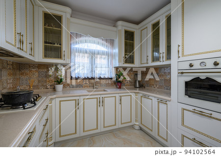 White classic cozy kitchen and dining room in city house 94102564