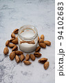 World Vegan Day concept. Nut milk in glass jar with almond. Homemade alternative dairy product. Plant based, lactose free. Tasty and healthy. Selective focus 94102683