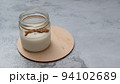 Glass jar with milk in daylight. World Vegetarian Day. Zero lactose, reusable package. Non-allergic nutrition. Homemade food. 94102689
