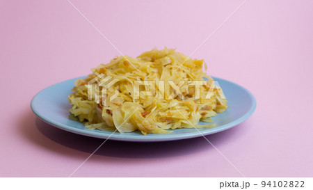 Stewed white cabbage on a plate. A dish of Russian cuisine. Garnish in the USSR. Stewed white cabbage on a plate. A dish of Russian cuisine. Garnish in the USSR. 94102822