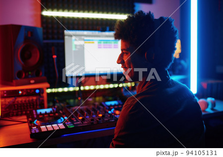 Happy smiling music producer in recording studio Happy smiling music producer in recording studio 94105131