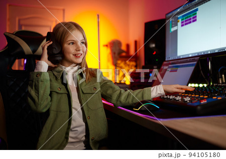 Young audio engineer mixing sound at production house Young audio engineer mixing sound at production house 94105180