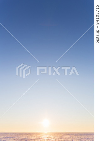 Vertical beautiful landscape, clear blue sky, low horizon, sunrise or sunset. Beauty in nature. Universal natural gradient background. Concept of freedom, tranquility, unity with nature. Copy space. 94105715