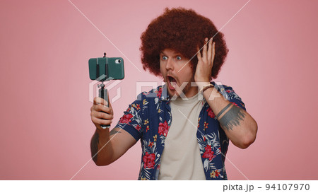 Man blogger take selfie on mobile phone selfie stick communicate video call online with subscribers 94107970