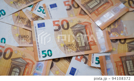 The background consists of many euro banknotes of different denominations. Finance and business concept 94108372