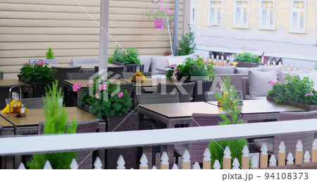 Summer terrace of the restaurant on a clear day. Table near the restaurant close-up Summer terrace of the restaurant on a clear day. Table near the restaurant close-up 94108373