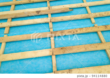 Top down detail of a wooden roof frame on a house under construction. Top down detail of a wooden roof frame on a house under construction. 94114880