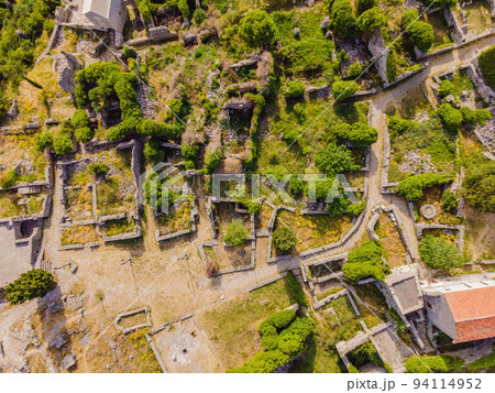 Old city. Sunny view of ruins of citadel in Stari Bar town near Bar city, Montenegro. Drone view Portrait of a disgruntled girl sitting at a cafe table Old city. Sunny view of ruins of citadel in Stari Bar town near Bar city, Montenegro. Drone view Portrait of a disgruntled girl sitting at a cafe table 94114952