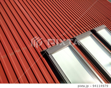 Red tiled house roof with attic windows. Roofing construction, window installation, modern architecture concept. 94114979