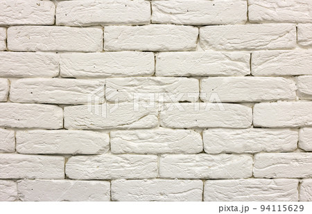 Close-up of white painted whitewashed solid brick wall. Abstract copy space background, Bricklaying, construction and masonry concept. 94115629
