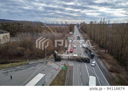 Aerial view of road accident with overturned truck blocking traffic Aerial view of road accident with overturned truck blocking traffic 94116674