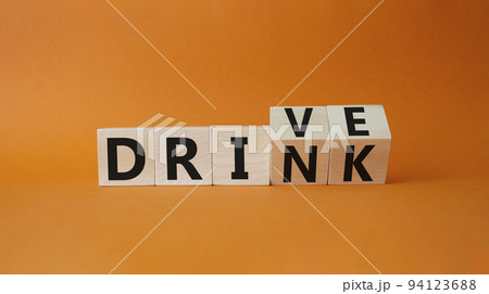Drive vs drink symbol. Turned cubes with words drink vs drive. Beautiful orange background. Business and Drive vs drink concept. Copy space 94123688