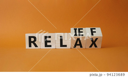 Relief and relax symbol. Turned cubes with words Relief and Relax. Beautiful orange background. Business and Relief and relax concept. Copy space Relief and relax symbol. Turned cubes with words Relief and Relax. Beautiful orange background. Business and Relief and relax concept. Copy space 94123689