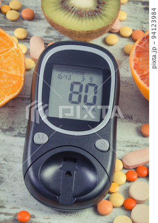 Glucometer with result of sugar level, fresh fruits and medical pills Glucometer with result of sugar level, fresh fruits and medical pills 94123984