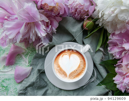 Pink peony flowers and cup of coffee Pink peony flowers and cup of coffee 94129609