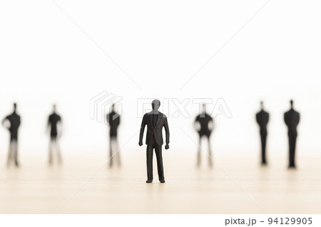 Leader posing with her team in blurred background. Successful team leader concept. Man figurine. Copy space 94129905