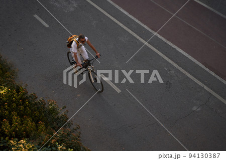 Man bicycling on cycling road. Top aerial view. 94130387