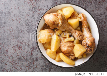 Indonesian cuisine chicken drumsticks stewed with potatoes in spicy sweet soy sauce close-up. horizontal top view 94131617