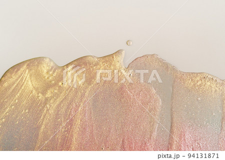 Beauty gel texture with pink and golden particles. Shining highlighter background with brush strokes 94131871