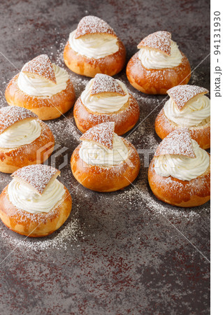 Semla vastlakukkel fastelavnsbolle fastlagsbull, Semlor, traditional scandinavian and estonian cardamom bun closeup. Vertical Semla vastlakukkel fastelavnsbolle fastlagsbull, Semlor, traditional scandinavian and estonian cardamom bun closeup. Vertical 94131930
