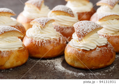 Semla Fastelavnsbolle Fastlagsbulle traditional scandinavian cream filled cardamom bun with almond paste closeup. Horizontal Semla Fastelavnsbolle Fastlagsbulle traditional scandinavian cream filled cardamom bun with almond paste closeup. Horizontal 94131931