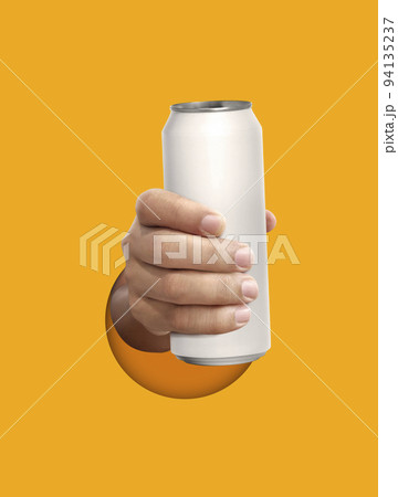Man holding aluminum can on yellow background 94135237