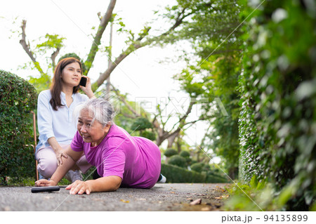 Asian senior woman fell down on lying floor because faint and limb weakness and pain from accident and woman came to help support and call emergency. Concept of old elderly insurance and health care Asian senior woman fell down on lying floor because faint and limb weakness and pain from accident and woman came to help support and call emergency. Concept of old elderly insurance and health care 94135899