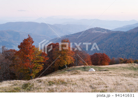 Autumn landscape with a tourist tent in the mountains Autumn landscape with a tourist tent in the mountains 94141631