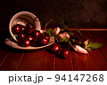 Cherry with hibiscus blossom on a dramatic dark background. still life photography. 94147268