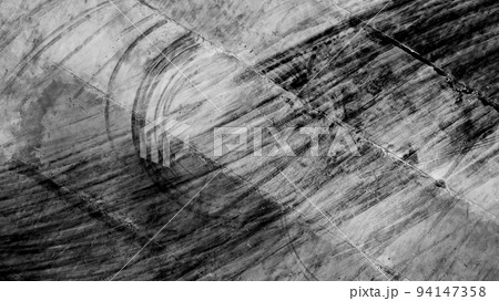 Aerial top view texture car skid tire marks on race track, Black tire mark tread marks on race track texture and background. Aerial top view texture car skid tire marks on race track, Black tire mark tread marks on race track texture and background. 94147358