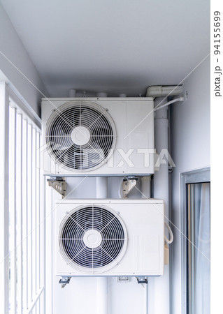 two air conditioning compressors are hung on wall. two air conditioning compressors are hung on wall. 94155699
