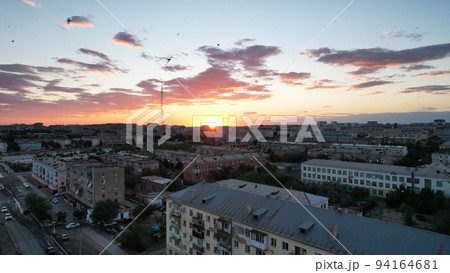 Orange sunset over small town. Top view from drone 94164681