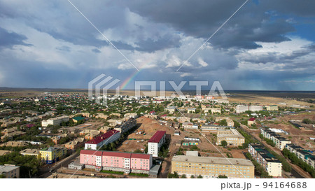 Bright rainbow and rain over the city of Balkhash Bright rainbow and rain over the city of Balkhash 94164688