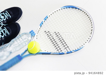 Tennis on a light background. sneakers, tennis racket, ball, 94164892