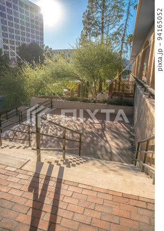 Staircase with bricks and floor mounted handrails at downtown Tucson, Arizona 94165052
