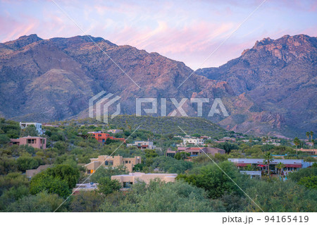 Sloped residential area with wild shrubs and mediterranean houses at Tucson, Arizona Sloped residential area with wild shrubs and mediterranean houses at Tucson, Arizona 94165419