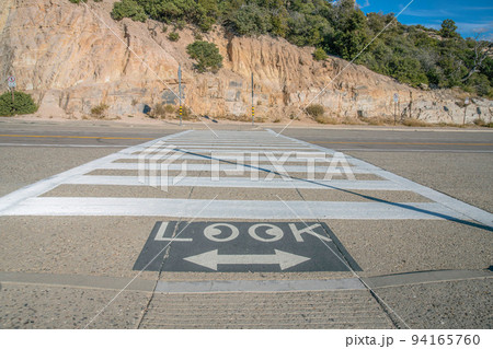 Mount Lemmon, Arizona- Crosswalk on a highway beside the rocky mountain wall 94165760